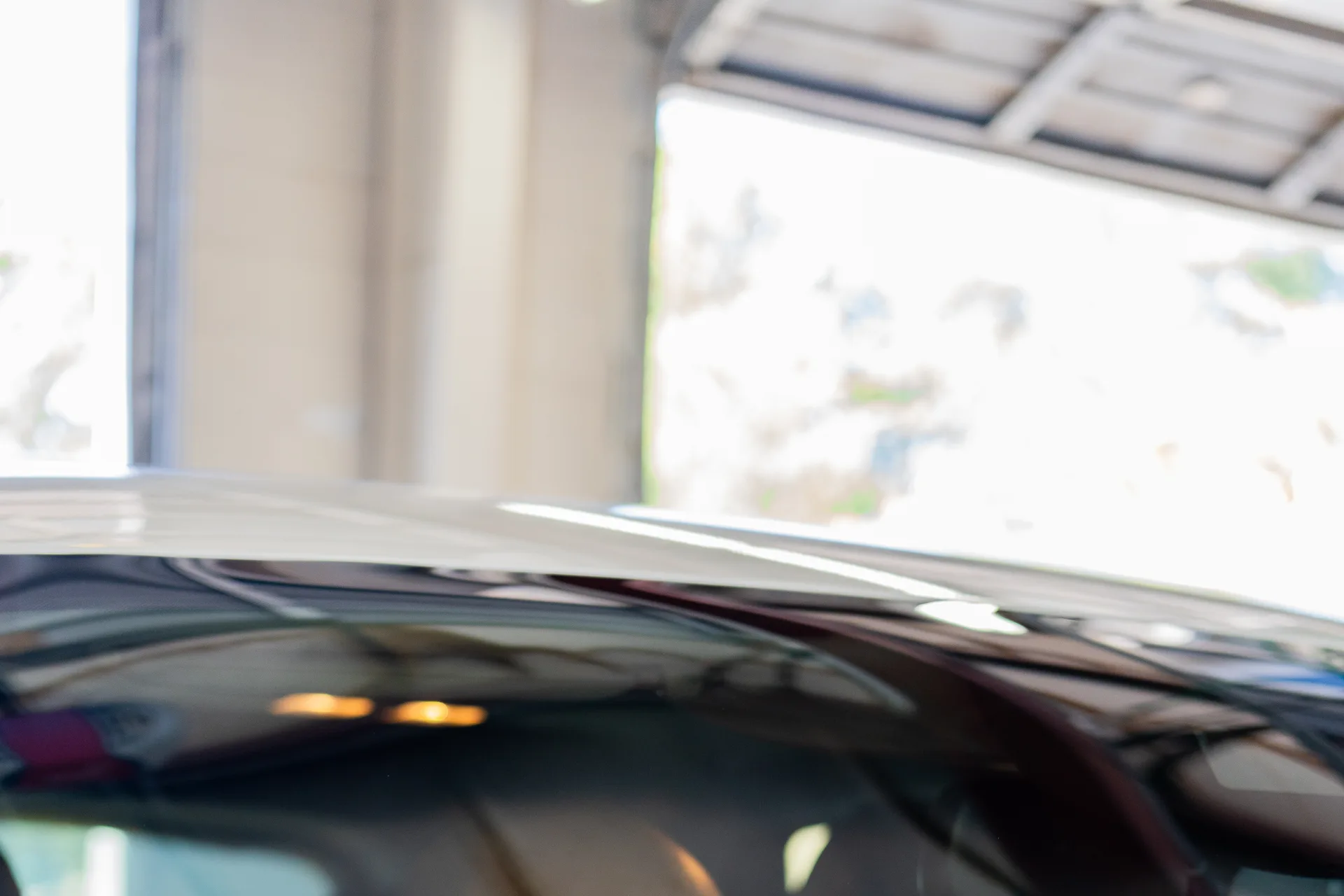 Technician inspecting windshield glass from inside the vehicle