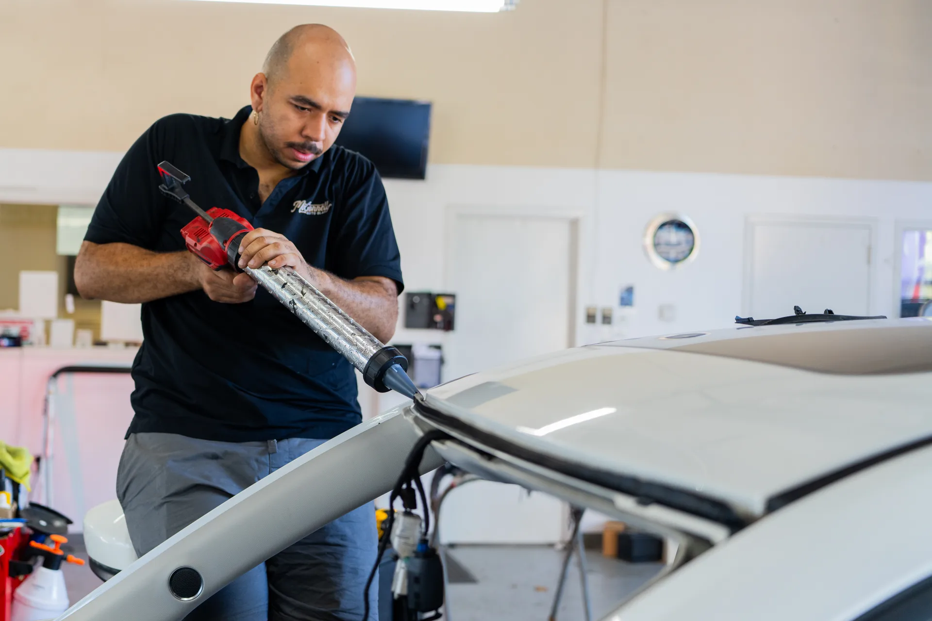 McConnell technician applying material during windshield repair work