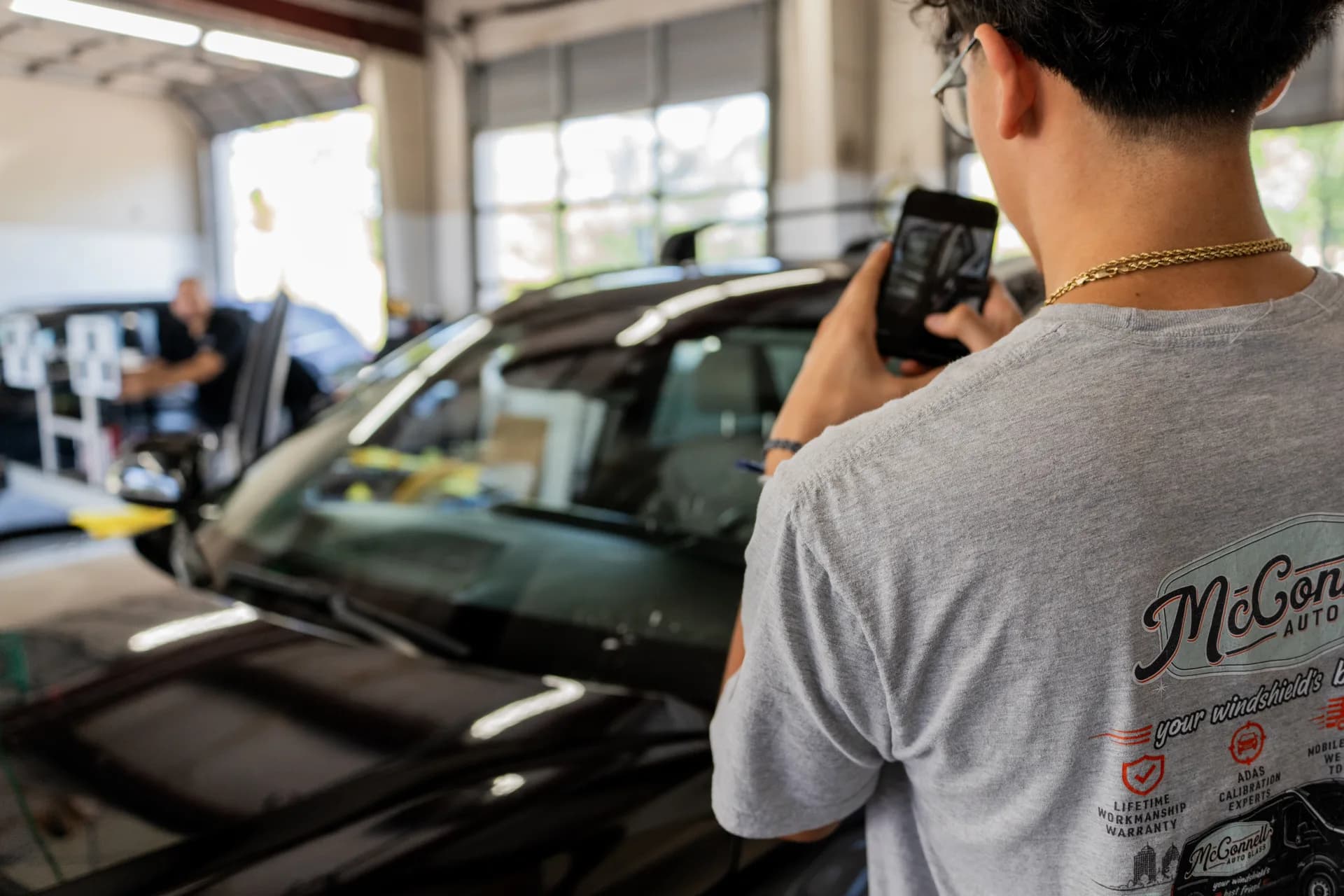 McConnell Auto Glass technician preparing a vehicle for glass service