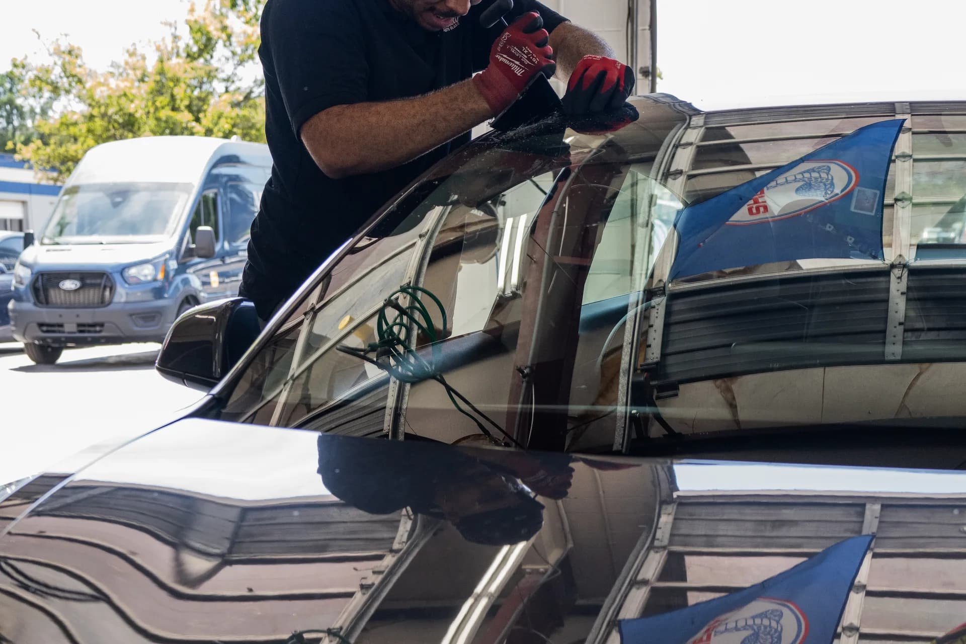 Close detail of vehicle glass and reflection during shop service